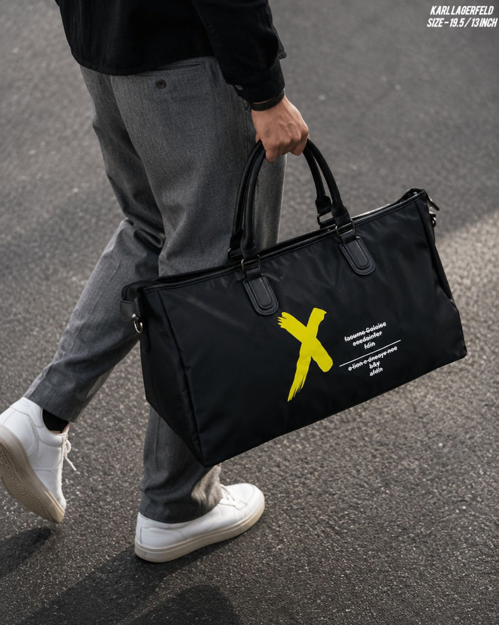 Supplier lifestyle photograph of the black duffel bag carried by hand
