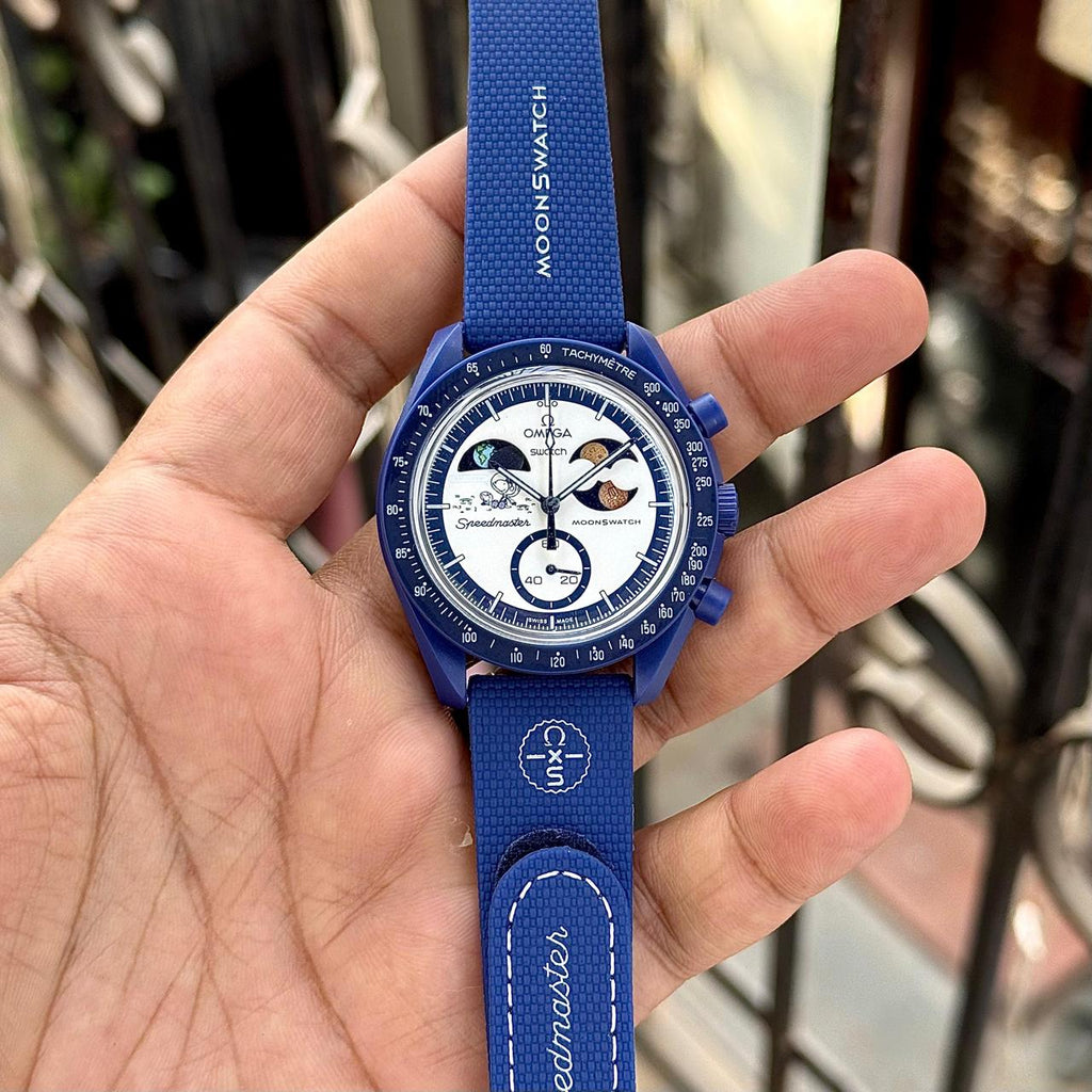 Full front view of the navy MoonSwatch Mission to Earthphase replica watch held in hand