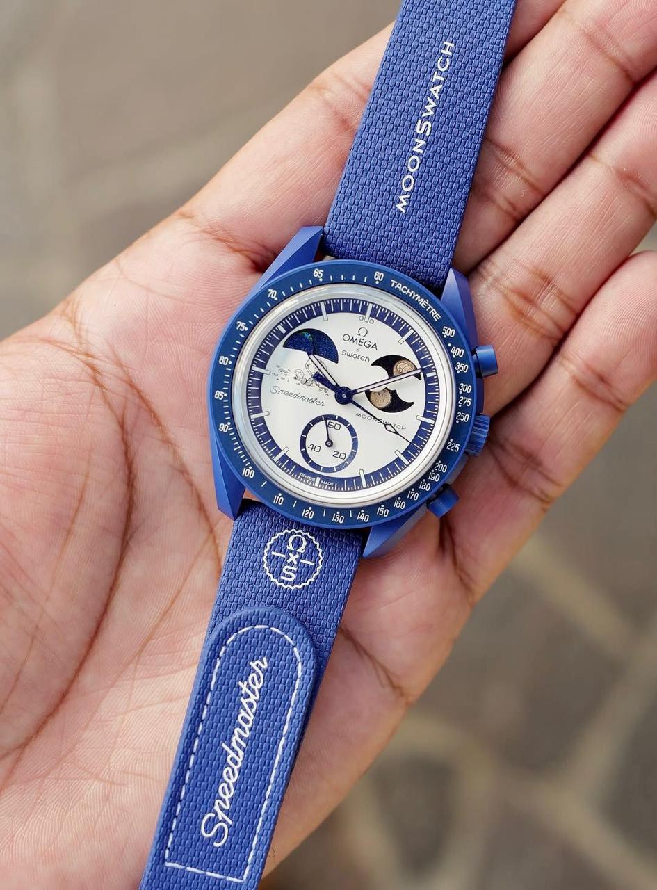 Navy MoonSwatch Mission to Earthphase replica watch showing the full textured fabric strap