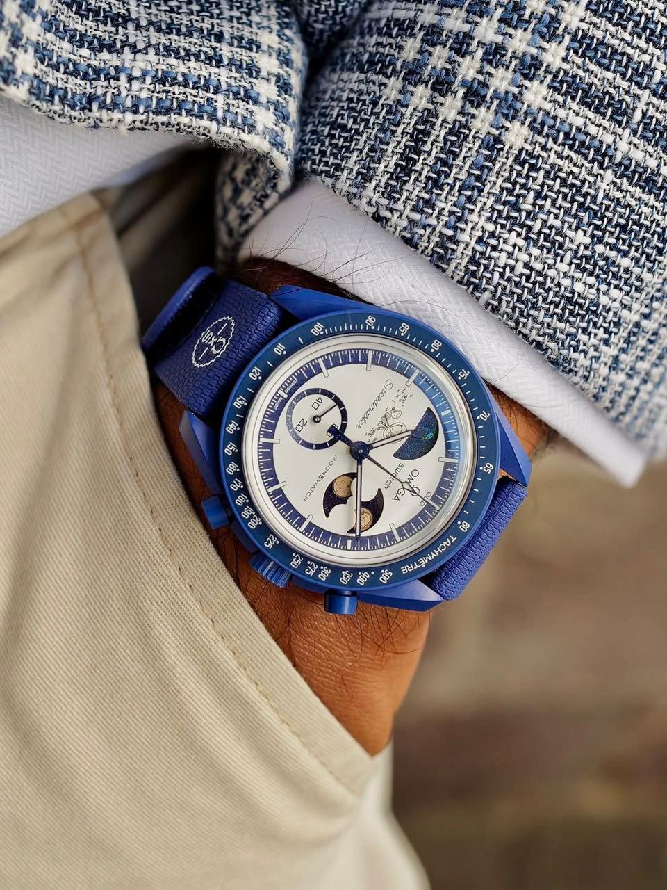 Angled wrist view of the navy MoonSwatch Mission to Earthphase replica watch