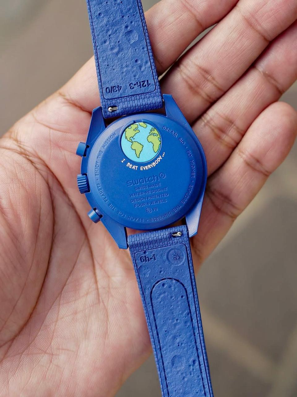 Supplied hand-held view of the navy caseback and strap underside