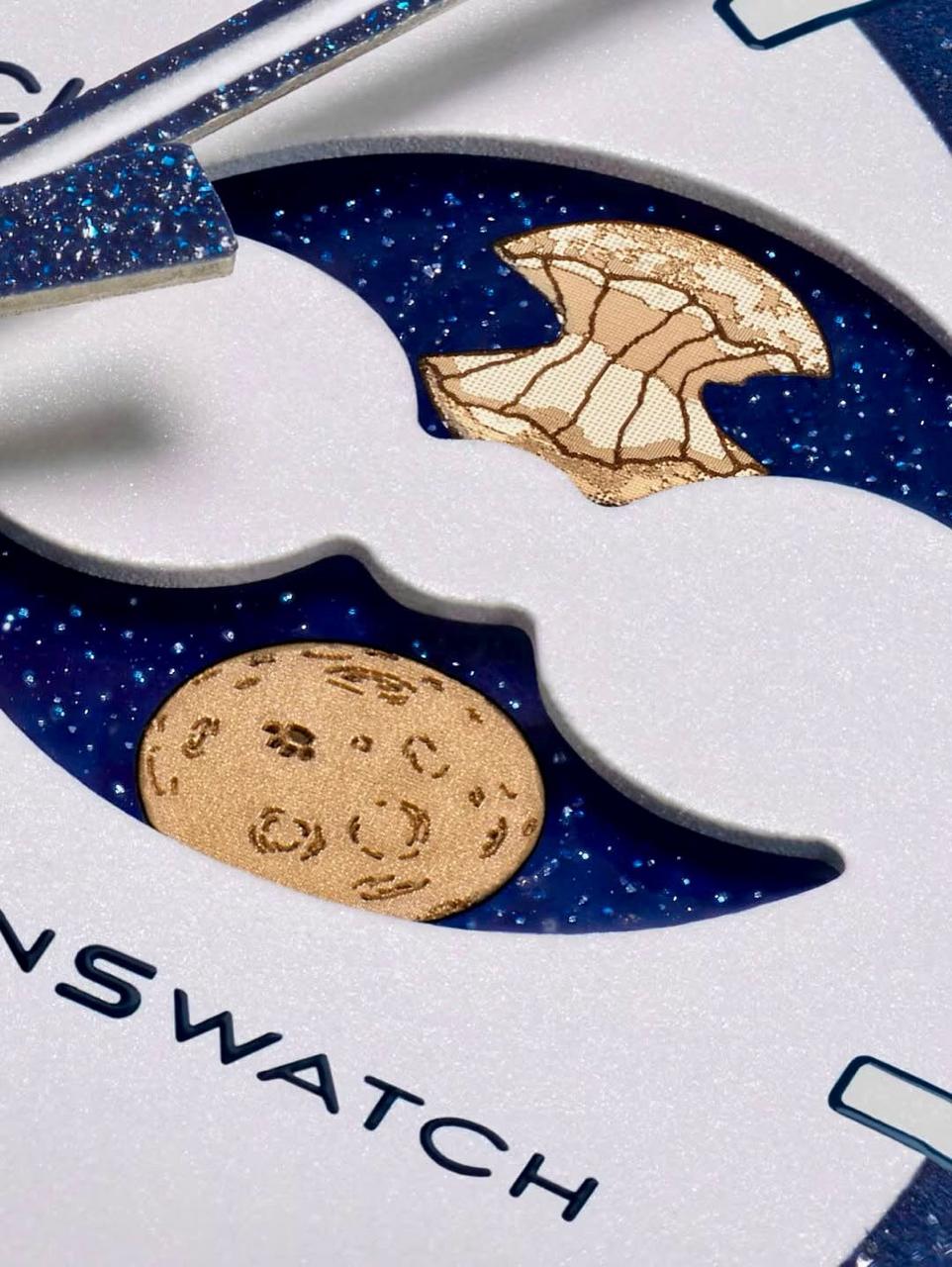 Macro view of the gold-toned moon-phase detail on the white and navy dial