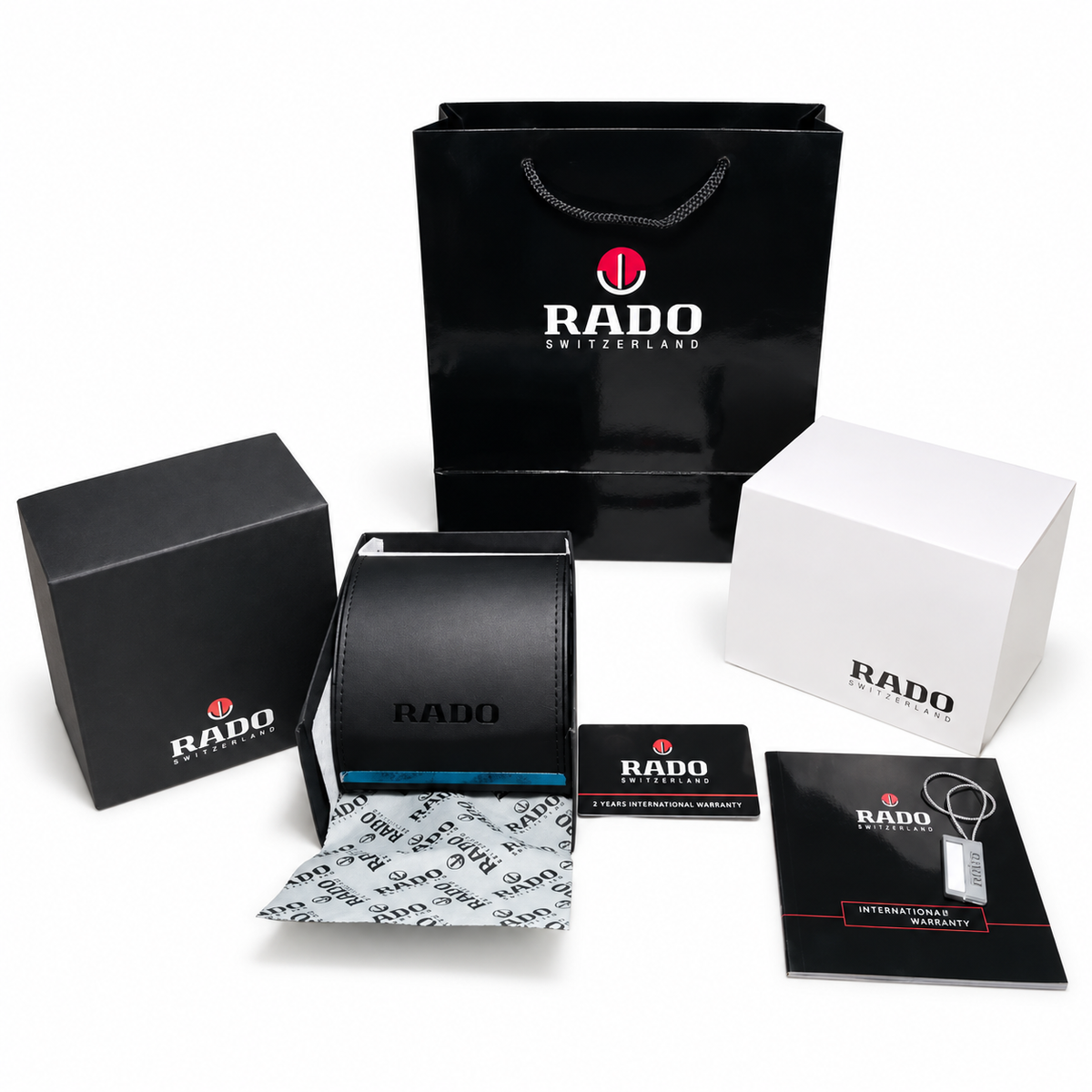 Optional Rado OG kit with curved presentation case, carry bag and paperwork on white; watch not included