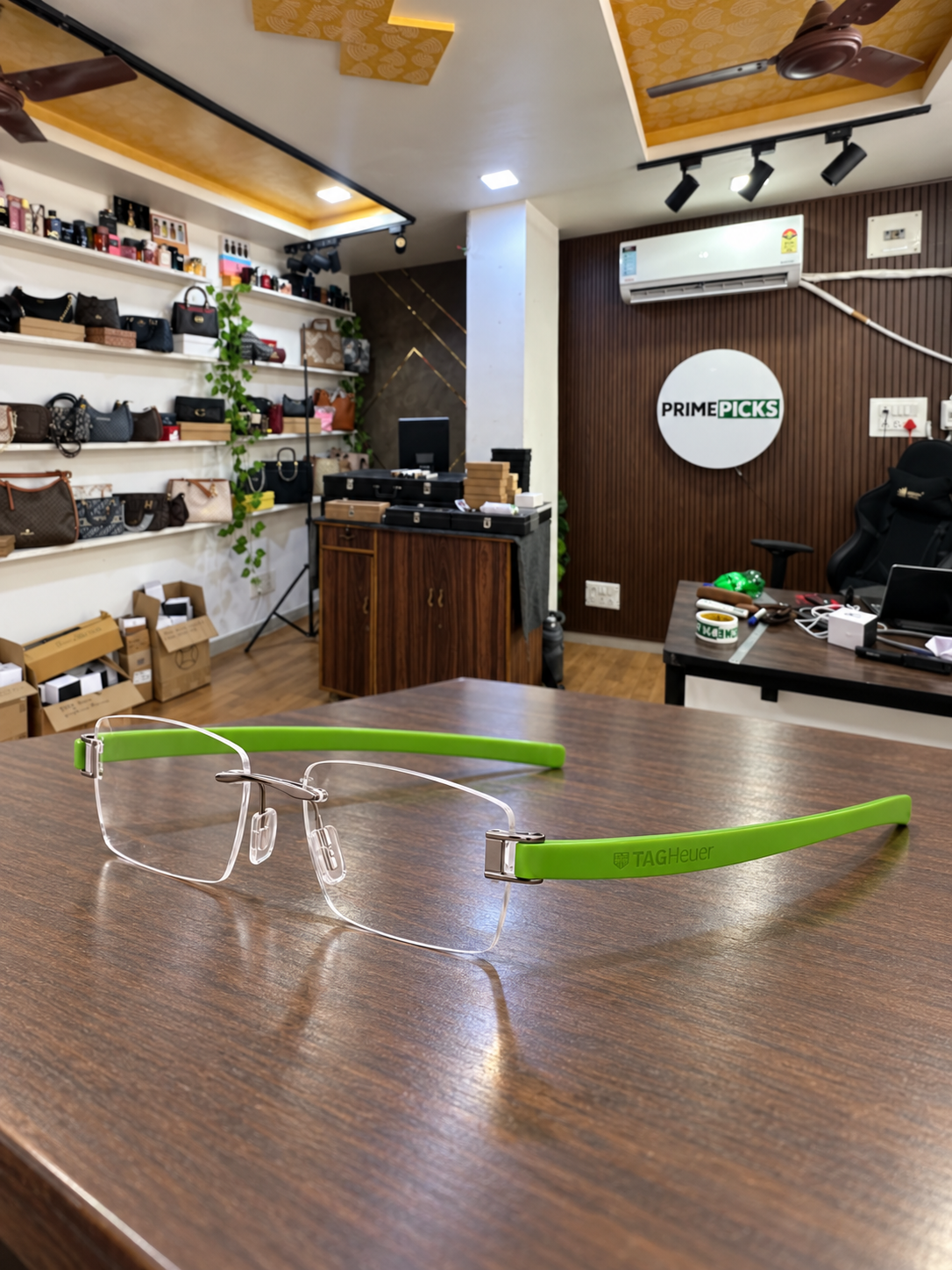 TAG Heuer rimless rectangular green temple optical frame in the actual PrimePicks office