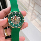 Handheld front view of the green and rose-gold Rado Captain Cook open-heart watch