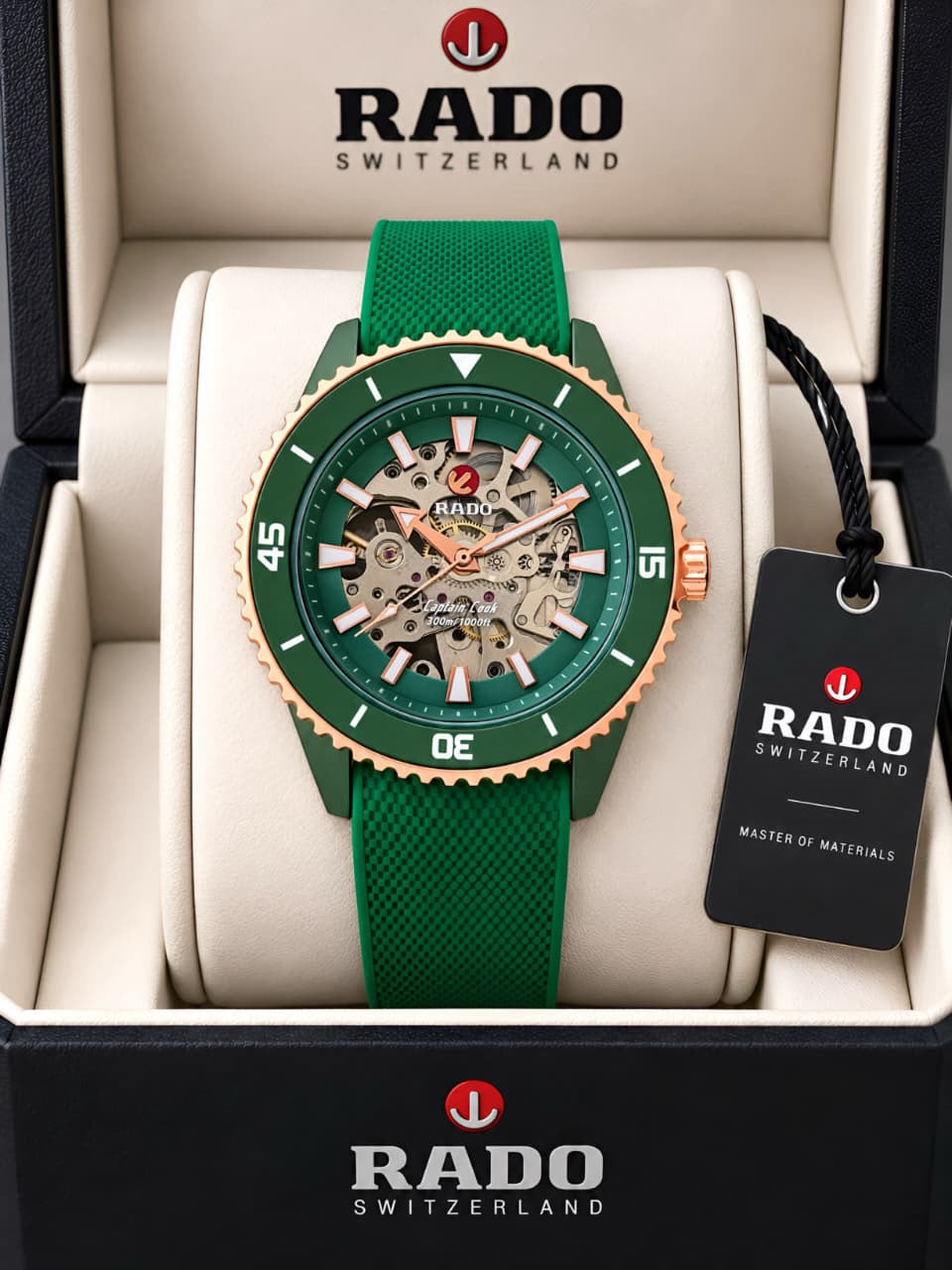 Green and rose-gold Rado Captain Cook watch displayed in a Rado-branded box