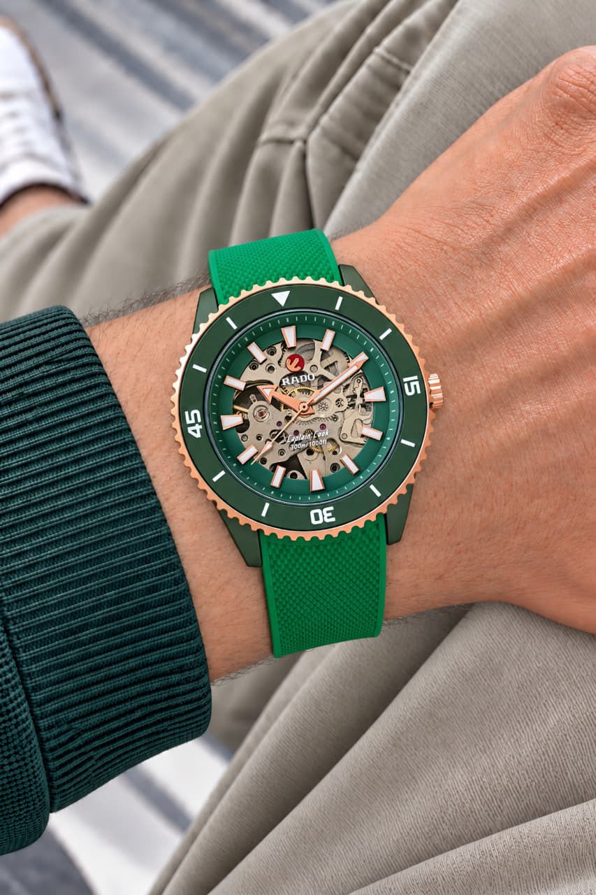Green and rose-gold Rado Captain Cook watch worn on wrist