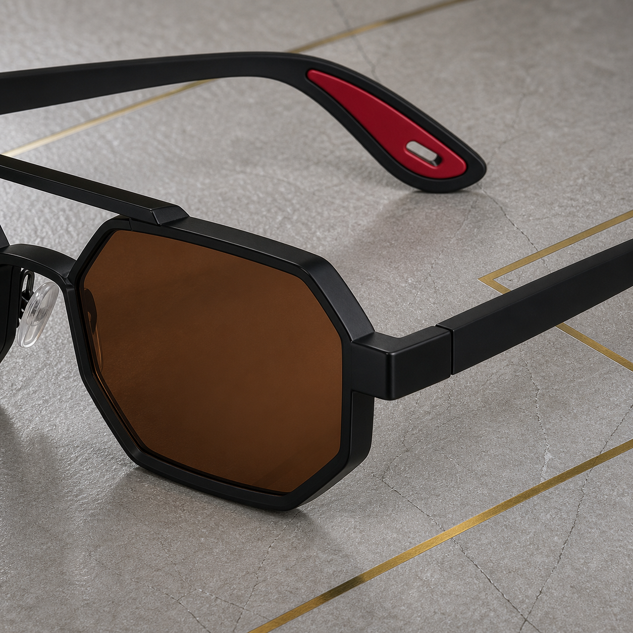 Close-up of angular black frame, brown lens and red temple-tip detail