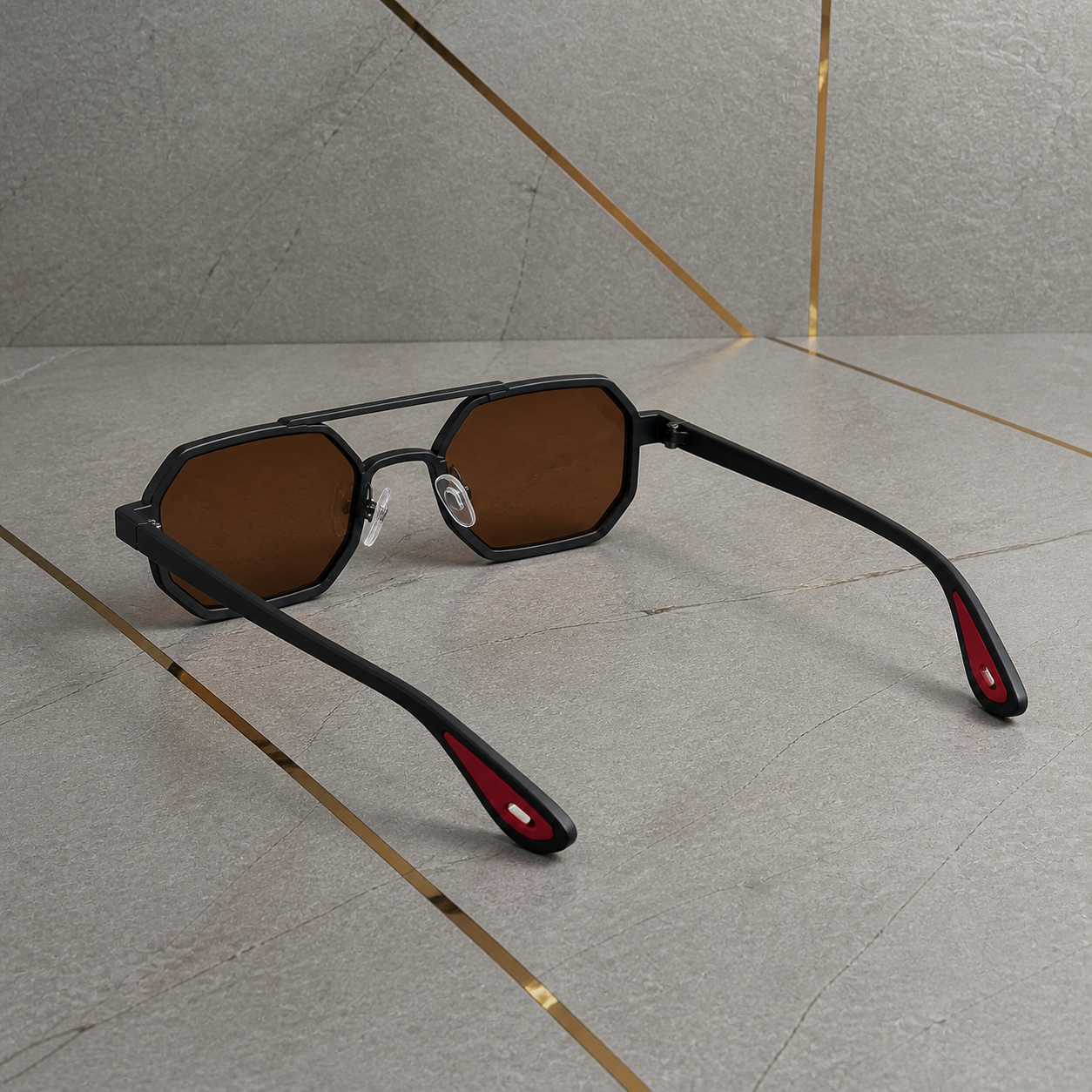 Rear three-quarter view of black angular sunglasses with red temple-tip insets
