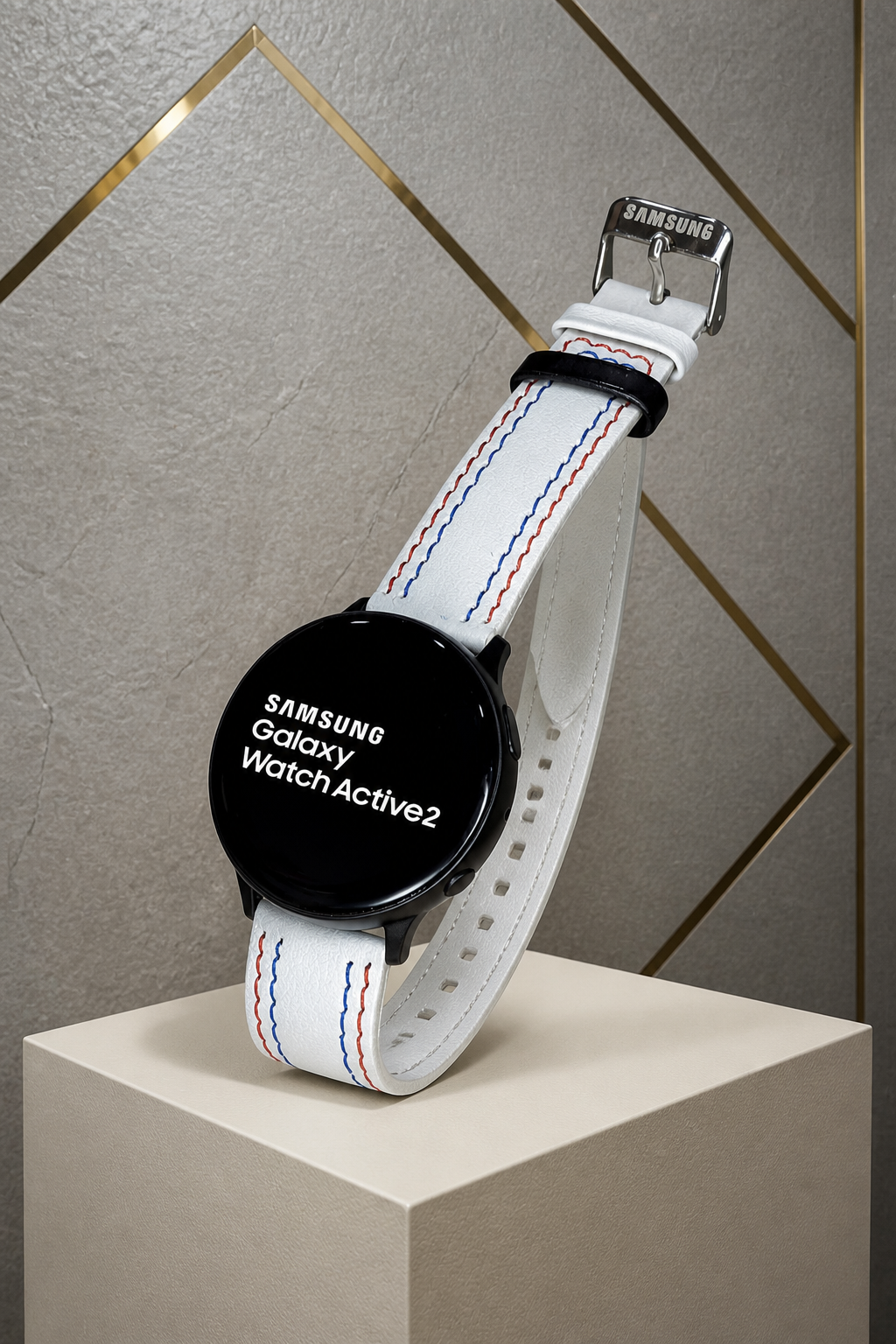 Samsung Galaxy Watch Active2 with white stitched strap against the grey and gold office wall