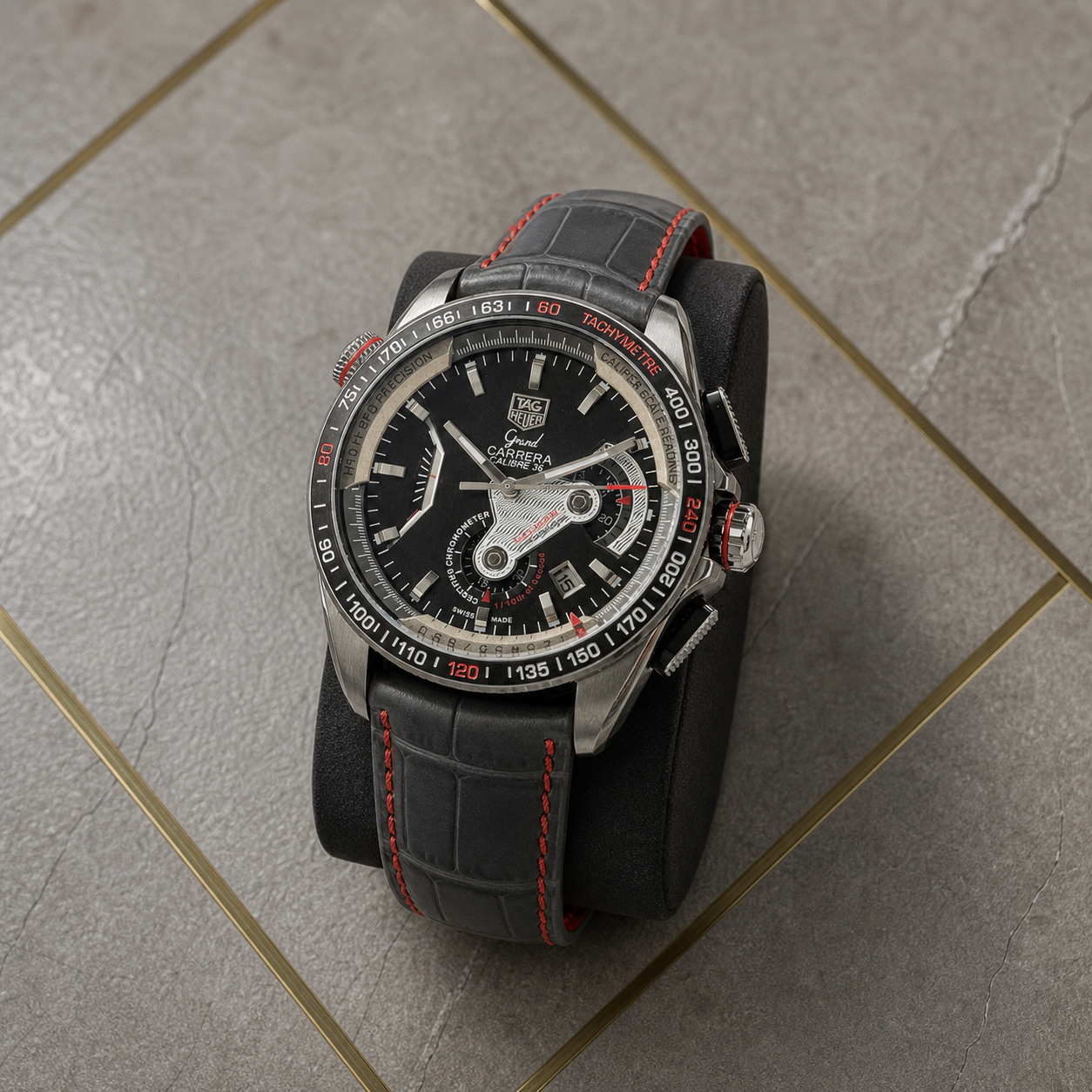 Three-quarter close-up of TAG Heuer Carrera Calibre 36 watch with red-stitched leather strap in the Primepicks office