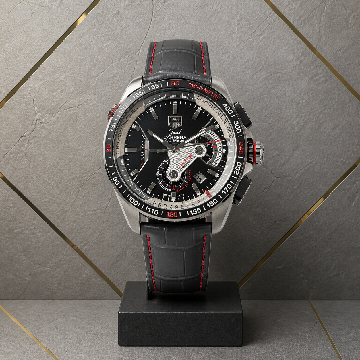 TAG Heuer Carrera Calibre 36 black chronograph against the grey and gold Primepicks office wall