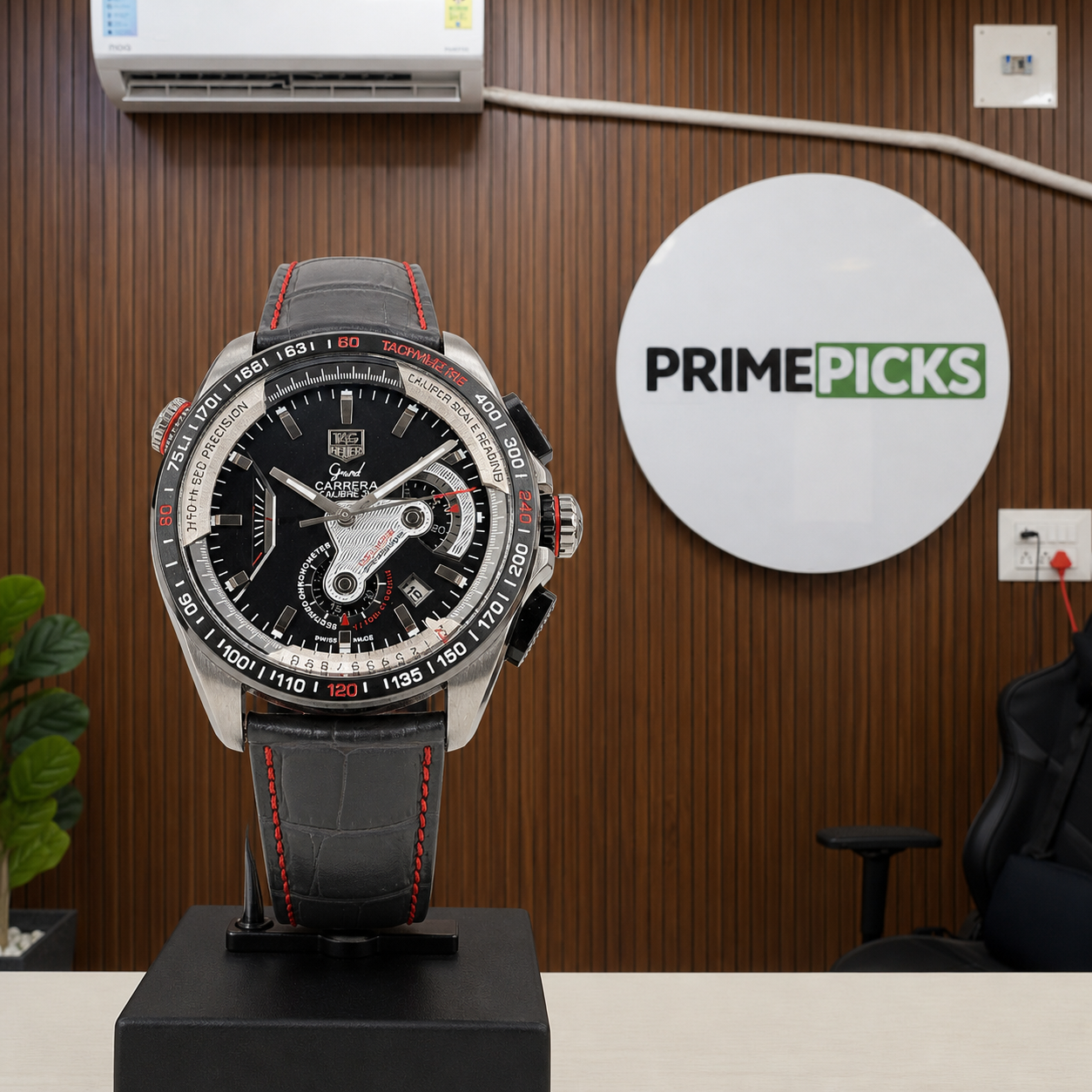 TAG Heuer Carrera Calibre 36 black chronograph watch beside the complete PRIMEPICKS logo board