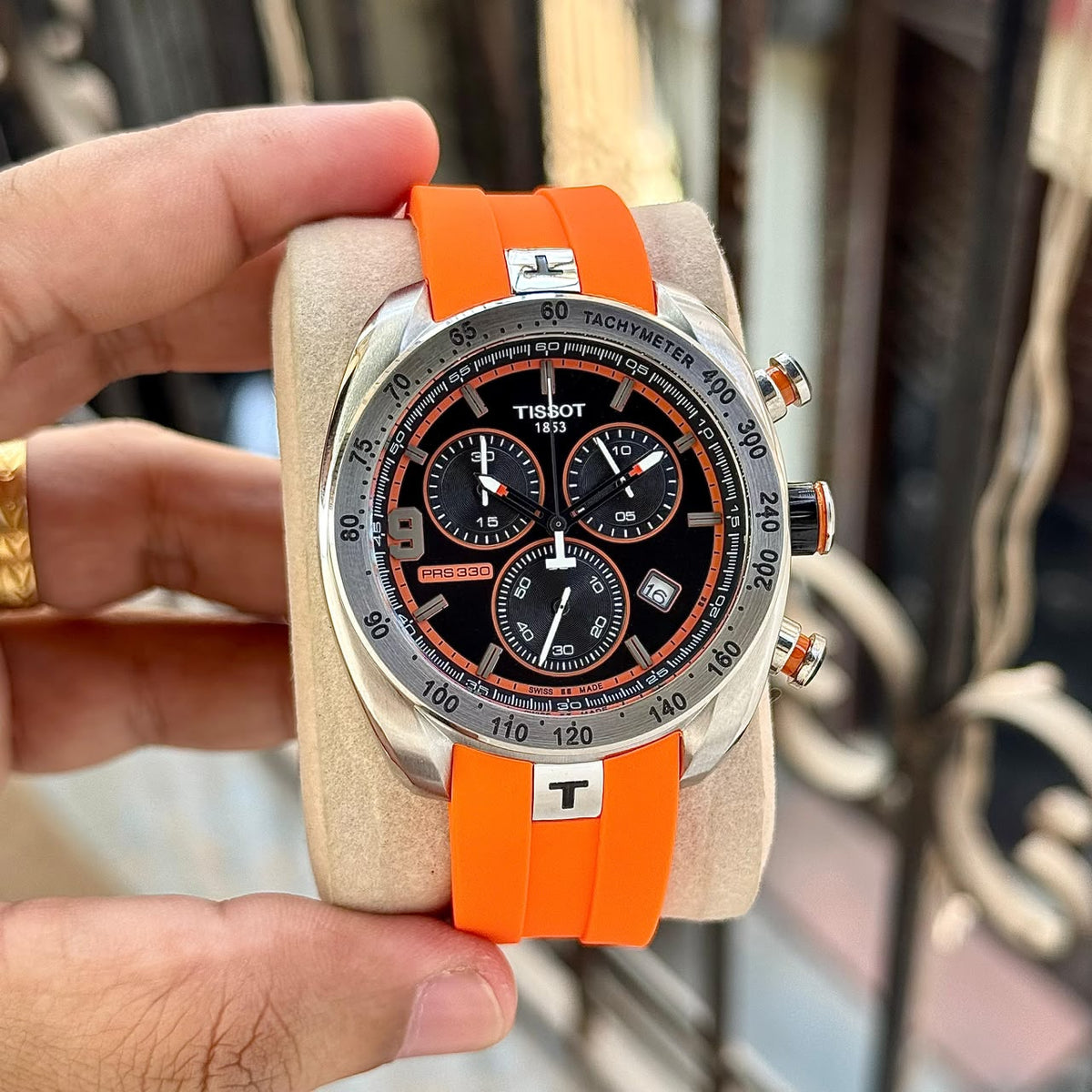 Tissot PRS 330 black chronograph dial and orange strap on cushion