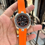 Close-up of Tissot PRS 330 chronograph watch with orange strap