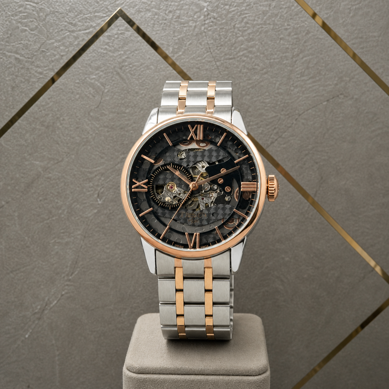 Tissot skeleton automatic two-tone watch on Primepicks grey office wall
