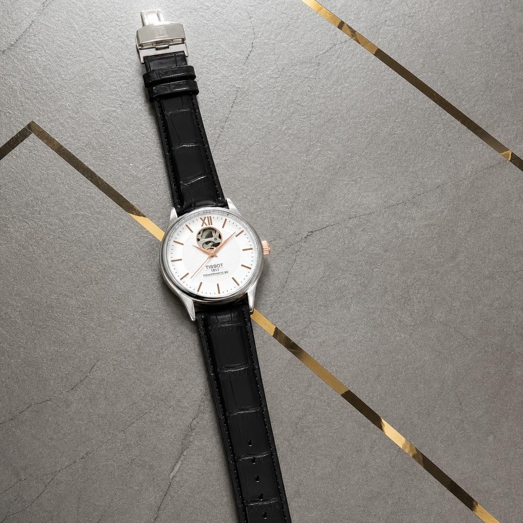 Tissot Tradition Powermatic 80 full watch on Primepicks gold-inlay office wall