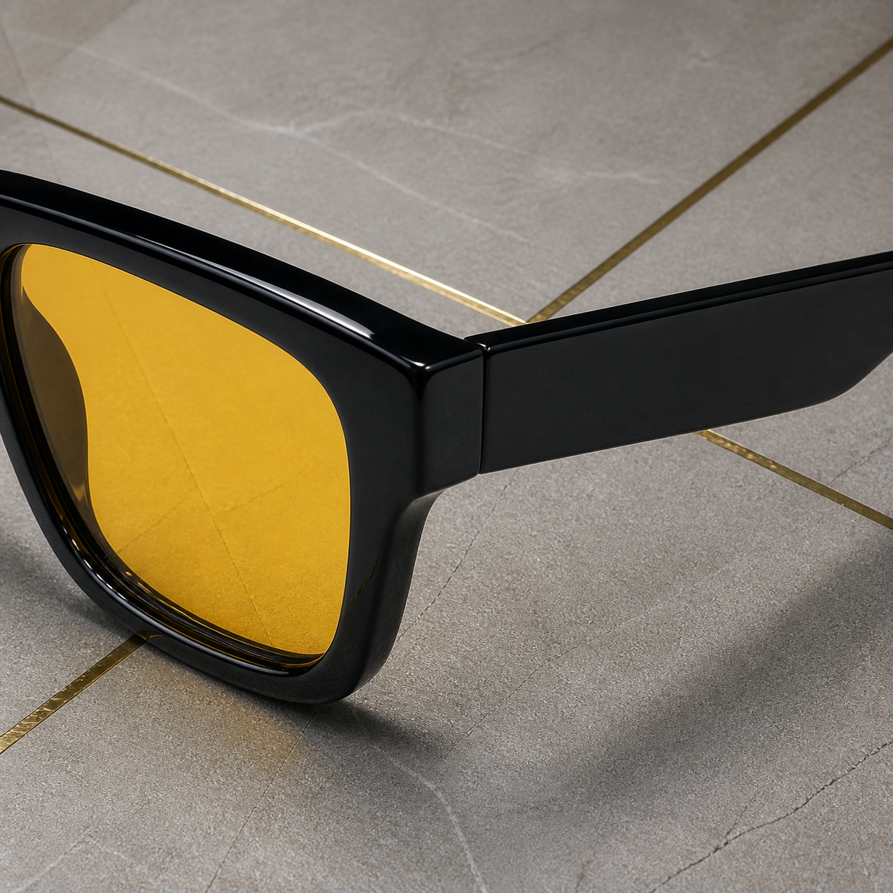 Close-up of glossy black frame, plain hinge and amber fiber lens