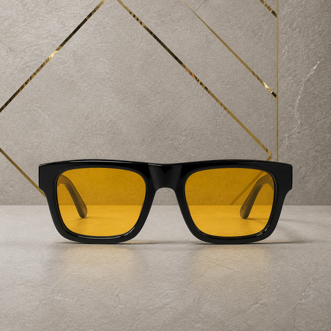 Straight-on view of glossy black square sunglasses with amber lenses