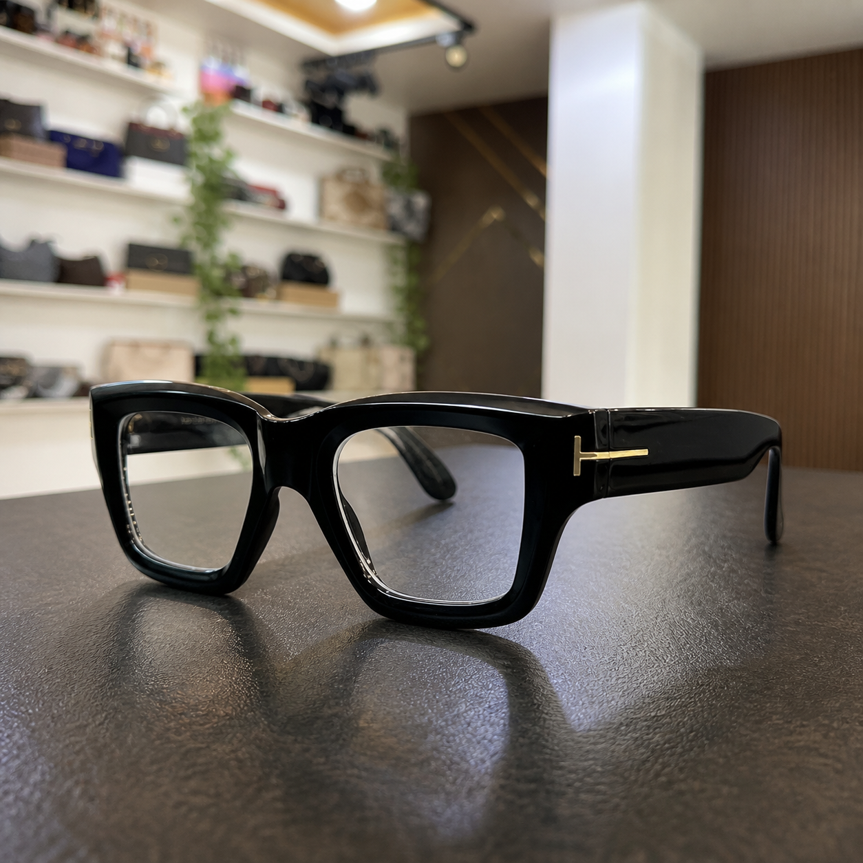 Tom Ford unisex angular square eyewear in Glossy Black / Clear Lens, office lifestyle view