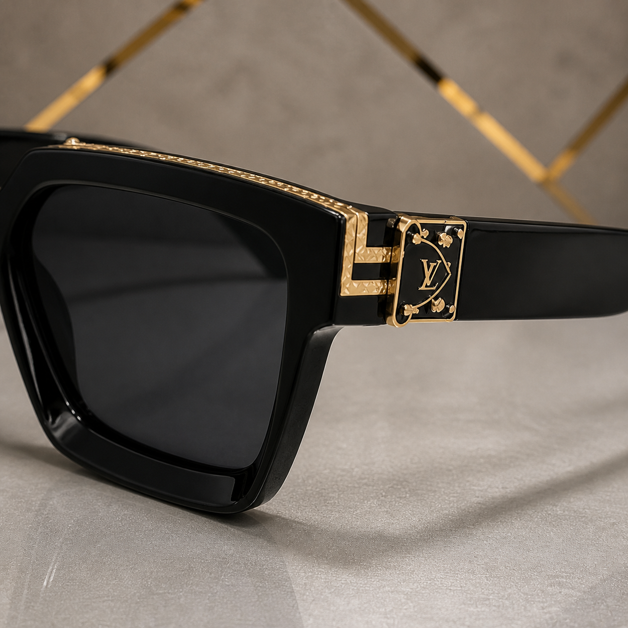 Louis Vuitton black angular square sunglasses with gold-tone accents and charcoal lenses, decorative hinge detail
