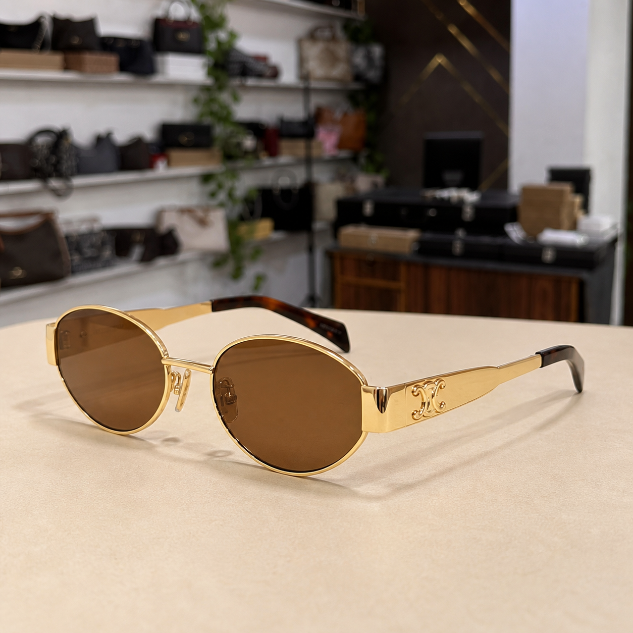 Celine gold-tone oval sunglasses with brown lenses, three-quarter right view