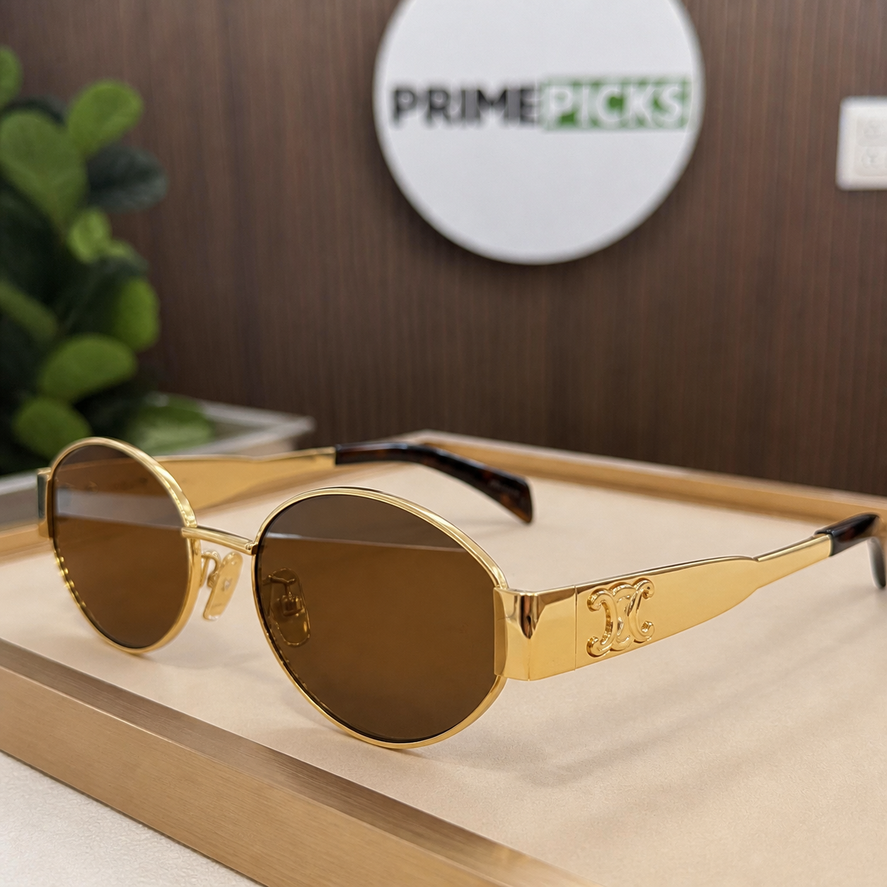 Celine gold-tone oval sunglasses with brown lenses, ornate hinge detail