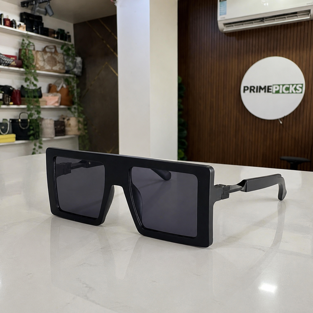 Marc Jacobs matte black oversized flat-top rectangular sunglasses with dark smoke lenses, alternate three-quarter view