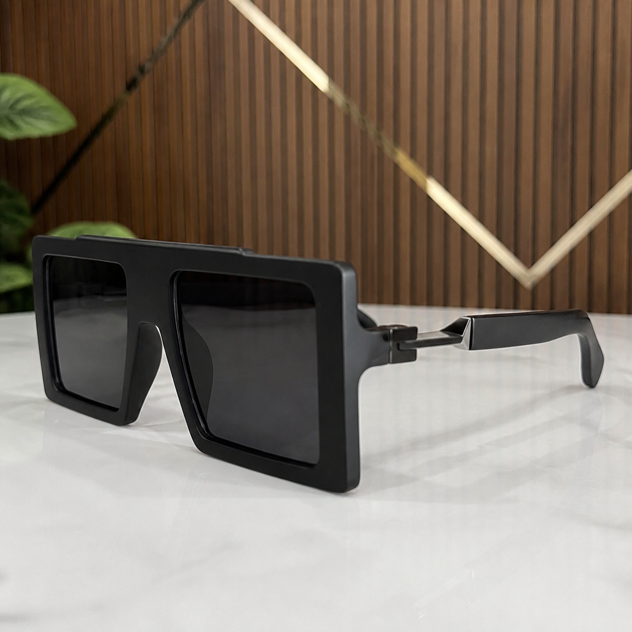 Marc Jacobs matte black oversized flat-top rectangular sunglasses with dark smoke lenses, angular hinge detail