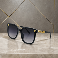 Chanel black butterfly sunglasses with smoke gradient lenses, front three-quarter hero view