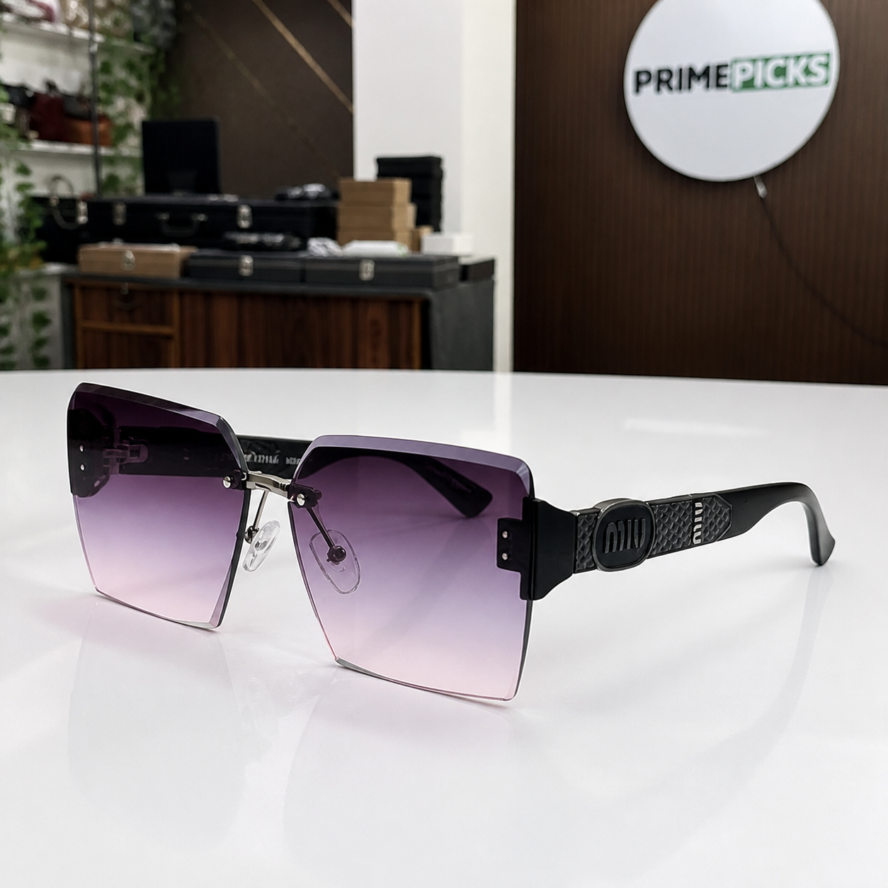 Miu Miu black-temple oversized rimless square sunglasses with gunmetal-tone hardware and smoky mauve gradient lenses, alternate three-quarter view