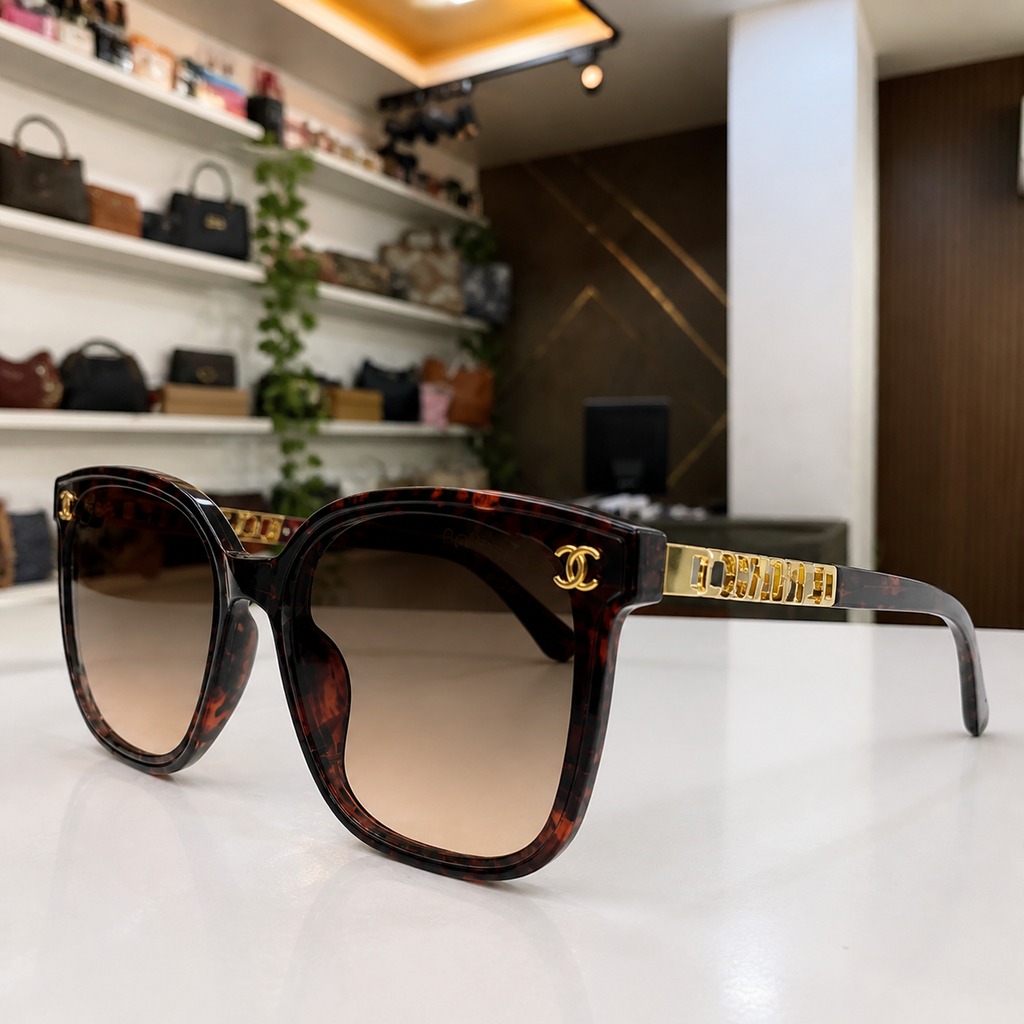 Chanel burgundy tortoiseshell butterfly sunglasses with brown gradient lenses, gold-tone emblem and hinge detail