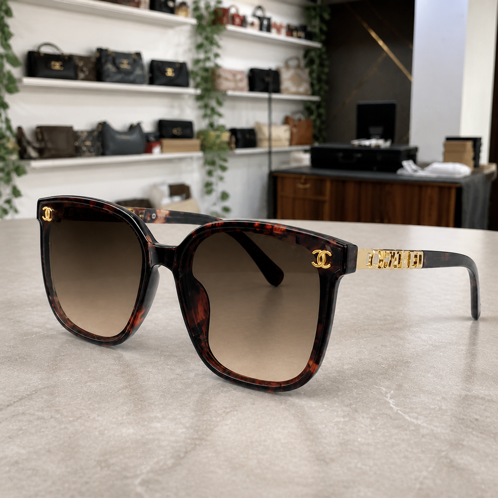 Chanel burgundy tortoiseshell butterfly sunglasses with brown gradient lenses, PrimePicks office lifestyle view
