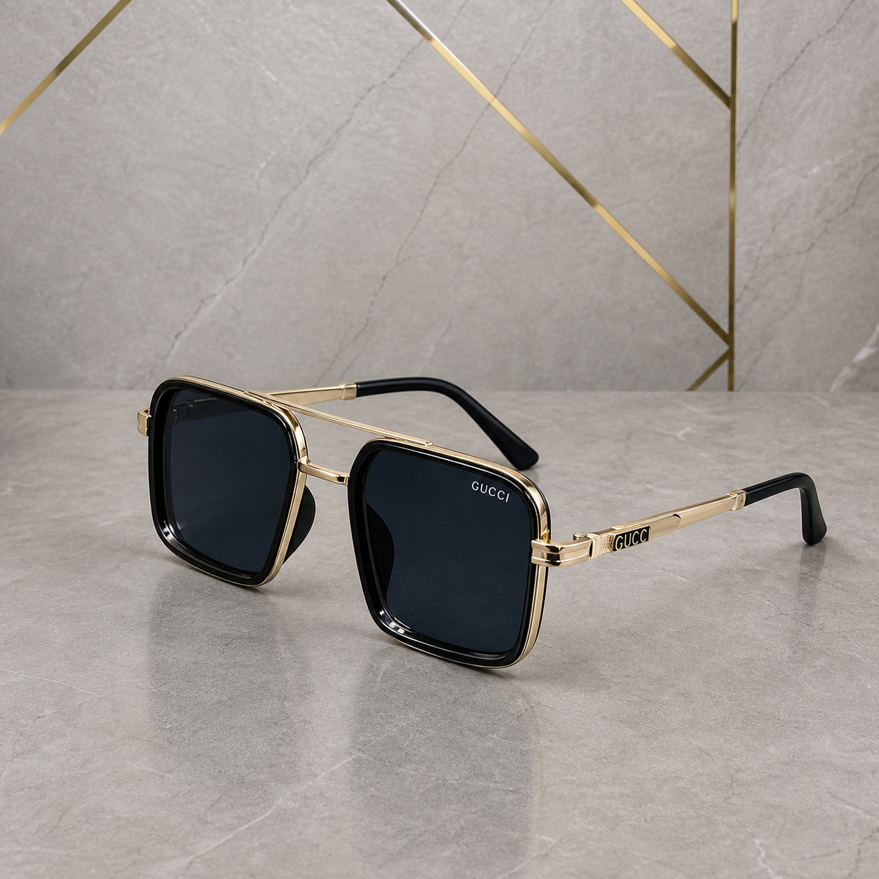 Gucci gold-and-black square double-bridge sunglasses with dark blue lenses, front three-quarter hero view