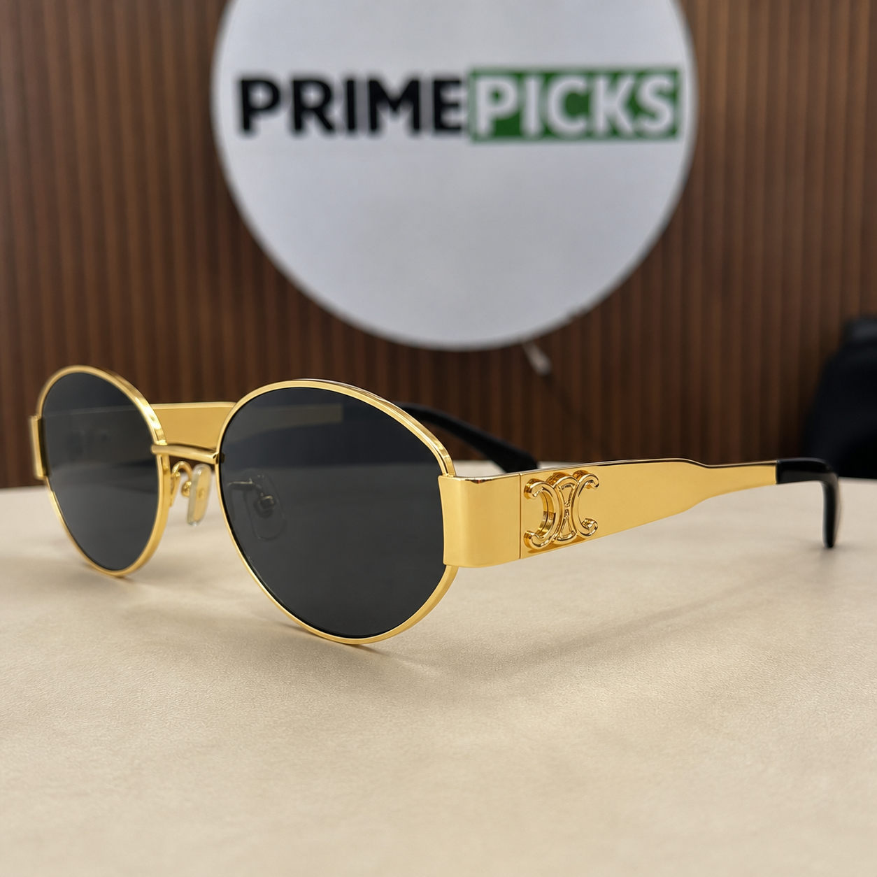 Celine gold-tone oval sunglasses with smoke lenses, ornate hinge detail