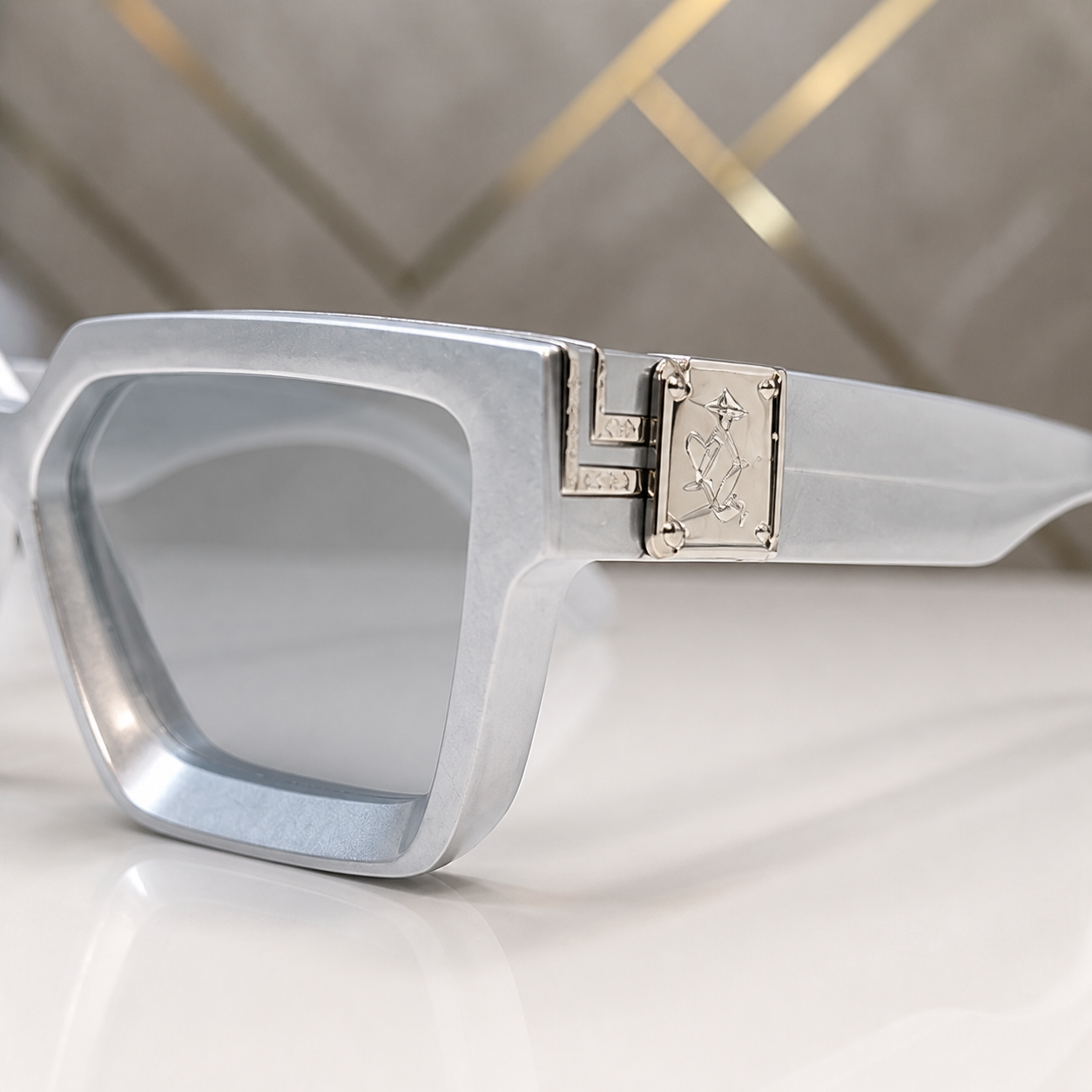 Louis Vuitton icy grey angular square sunglasses with smoke lenses, decorative hinge detail