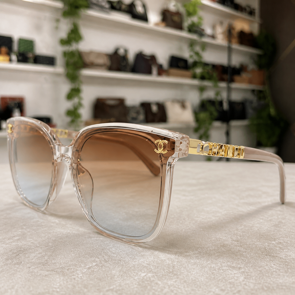 Chanel crystal-blush butterfly sunglasses with brown gradient lenses, gold-tone emblem and hinge detail