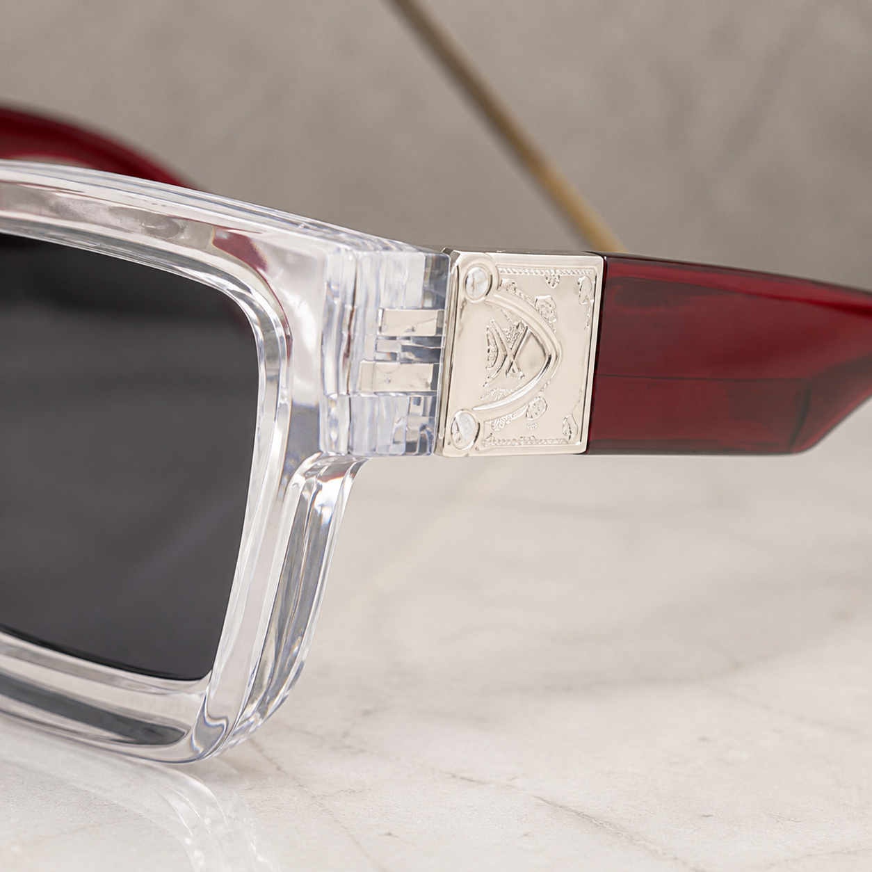 Louis Vuitton crystal angular square sunglasses with burgundy temples and smoke lenses, decorative hinge detail