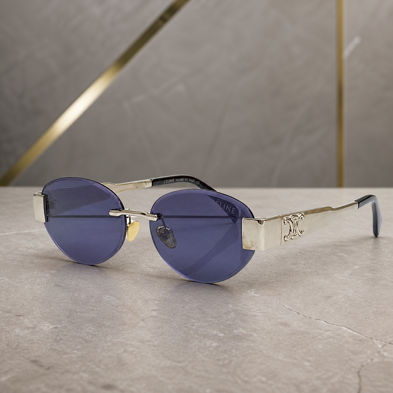 Celine silver-tone rimless round sunglasses with blue-violet lenses, folded overhead view