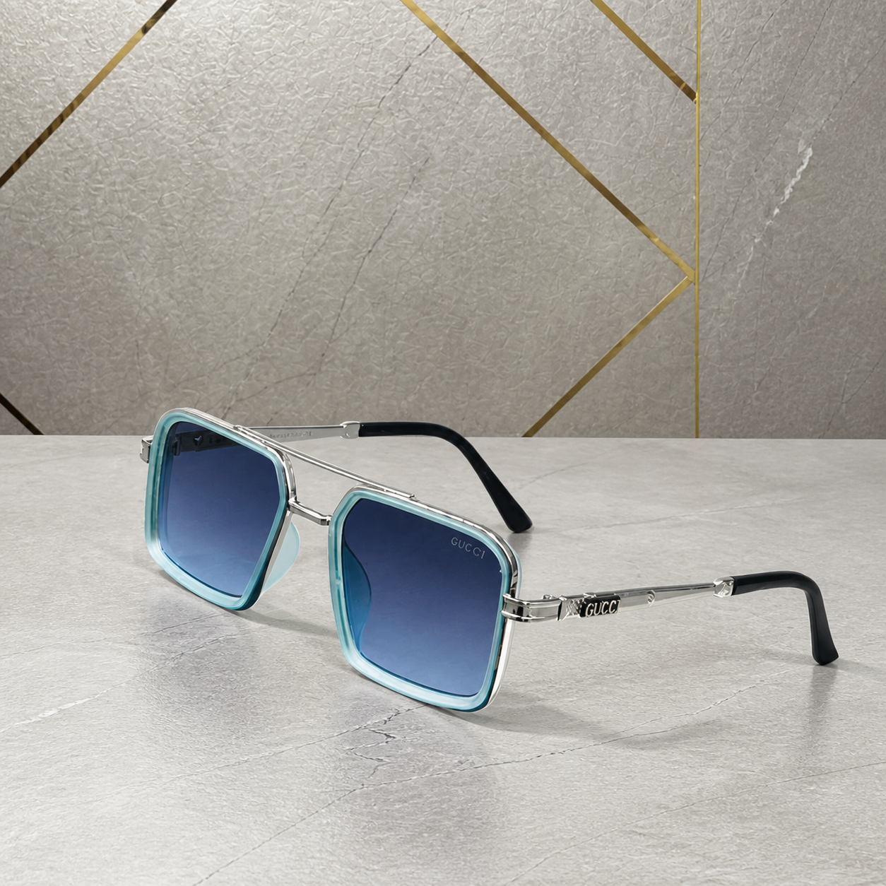 Gucci silver-and-aqua square double-bridge sunglasses with blue gradient lenses, front three-quarter hero view