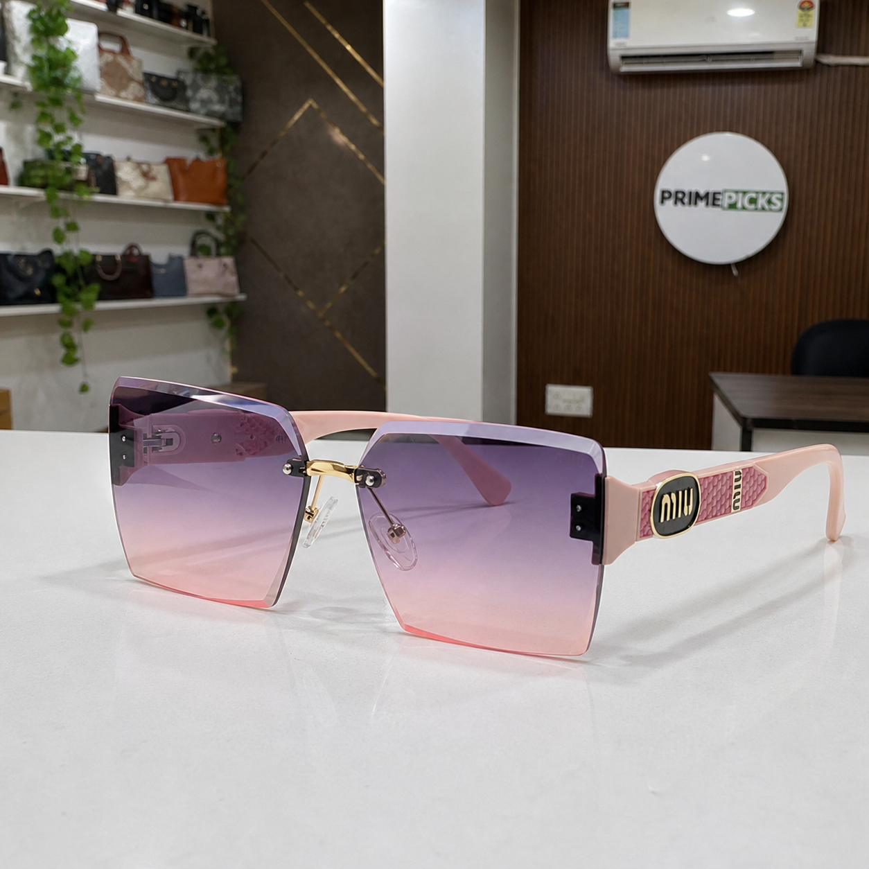 Miu Miu blush pink-temple oversized rimless square sunglasses with gold-tone hardware and violet-to-rose gradient lenses, front three-quarter hero view