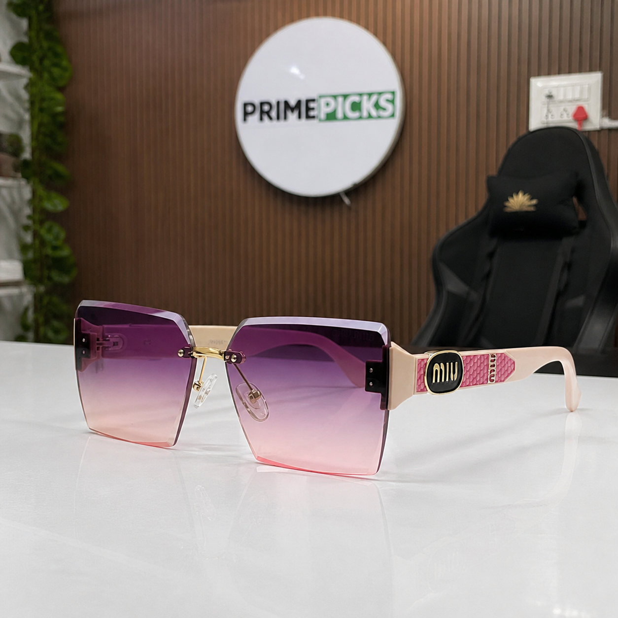 Miu Miu blush pink-temple oversized rimless square sunglasses with gold-tone hardware and violet-to-rose gradient lenses, PrimePicks office lifestyle view