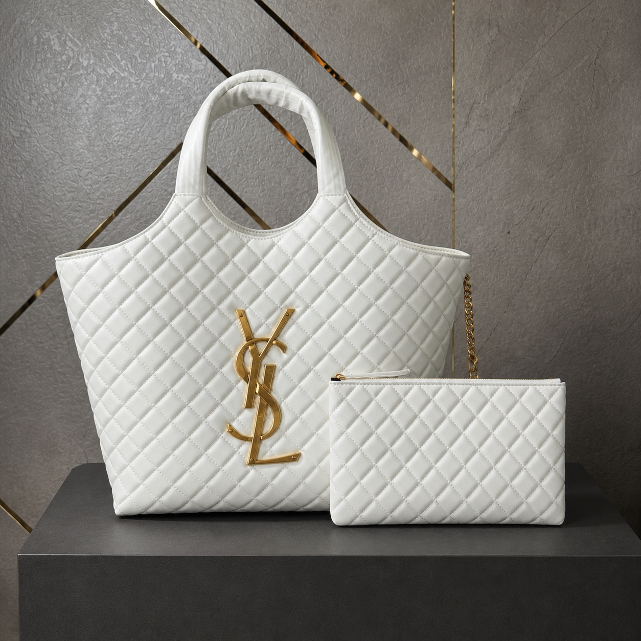 White quilted YSL Icare Maxi Tote and pouch on grey-gold office wall